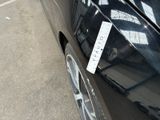 a sticker on the side of a car that is parked on the side of the road