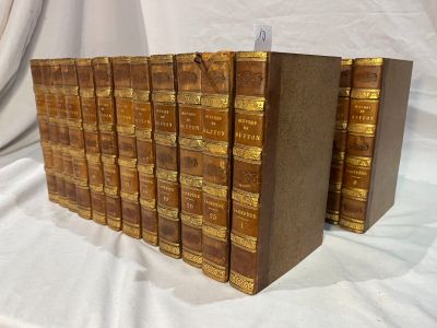 several books are lined up in a row on a white cloth