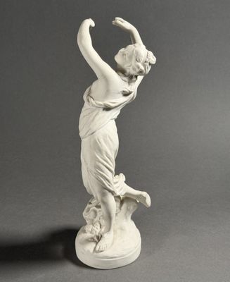 an antique statue of a woman holding a bird in her hand