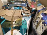 a cardboard box filled with many different types of luggage