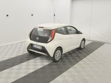 a small white car parked in a garage