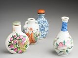 three small vases with designs on them sitting next to each other