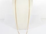 a gold chain necklace on a mannequin mannequin