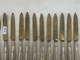 an assortment of silverware including knives, spoons and knives