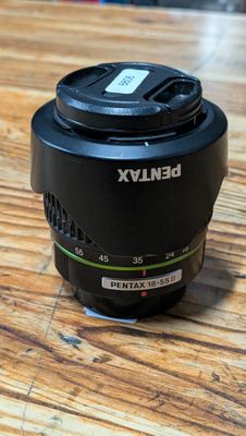 a camera lens on a wooden table with a blurry background