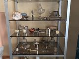 a glass shelf with various items on it in a room