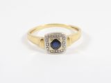 an image of a gold ring with a sapphire and diamonds
