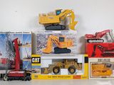 a lot of toy construction vehicles on the table