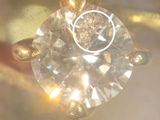 a close up of a ring with a diamond in it