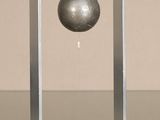 a metal object with a ball on it sitting on a table