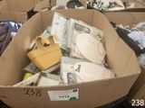 a cardboard box filled with assorted items in a room