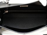 an image of a black and white handbag with a zipper