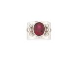 a close up of a ring with a ruby stone and diamonds