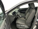 the interior of a car with the door open and the driver ' s seat down