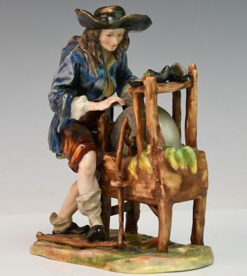 une image représentant une figurine d'un homme assis sur une chaise