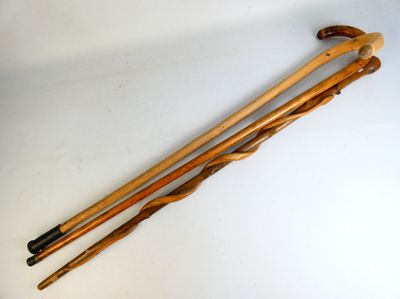 pair of wooden walking canes on a white surface