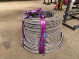 a coil of steel wire with a purple ribbon tied to it