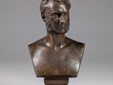 a bronze bust of a man on a pedestal