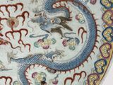 a plate with a dragon on it on a table