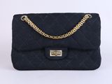 a black quilted bag with a gold chain strap