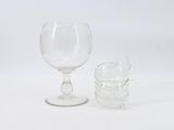 two empty wine glasses sitting next to each other on a white surface