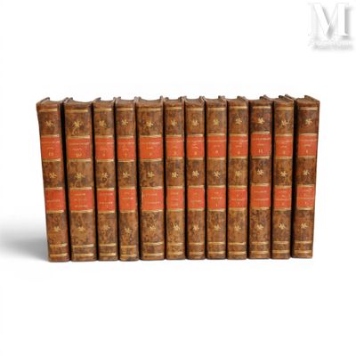 six old books lined up in rows on a white surface