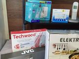 many electronic devices on a table in a room