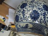 a blue and white vase sitting on top of a table