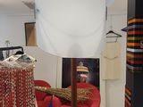 an image of a clothing store with a red chair in the corner