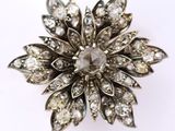 an image of a diamond flower broochle on a white background