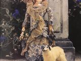 a doll and a dog standing in front of a statue
