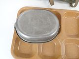 a tray with a pan and a lunch bag on the table