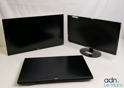 two monitors and a laptop are sitting on a white surface