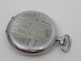 a silver pocket watch that is on a white surface