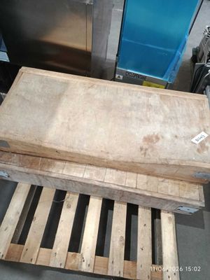 wooden pallets stacked on top of each other in front of a blue door