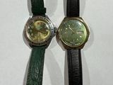 two watches sitting next to each other on a table