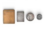 several different types of coins and a book on a white surface