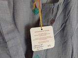 the back of a dress with a tag attached to it