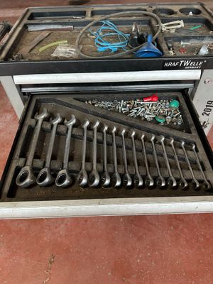 a tool box with tools in it sitting on the floor