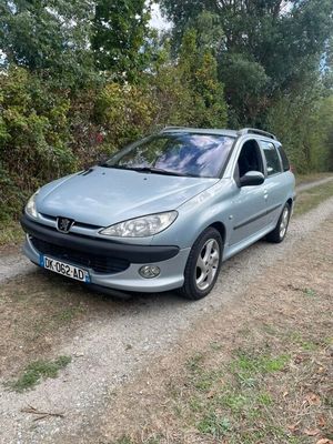 a picture of a car parked on a dirt road