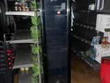 a refrigerator in the middle of a store with shelves full of food