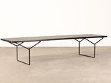 a black and white bench sitting on top of a cement floor
