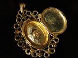 an image of a close up of a gold locke on a black surface