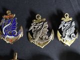 five different types of badges on a black surface