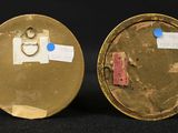 pair of antique brass plated clock faces with a blue dot