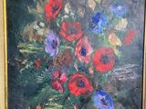 a painting of flowers in a gold frame on the wall