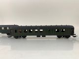 an image of a green train car sitting on top of a white surface