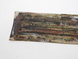 a piece of rust on the side of a piece of metal