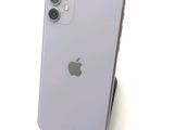 a white iphone sitting on top of a wooden stand