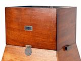 a wooden box that has a coin in it